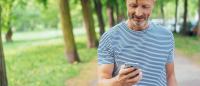 man looking at phone walking